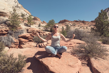 Fototapeta na wymiar Woman practices yoga and meditates on the mountain.