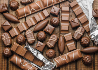 Background of chocolates, bars and sweets, free space for text, close up