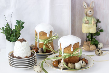 Easter still life with Easter cake kulich, paskha and painted eggs on a light background.