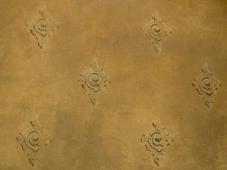 Yellow decorated cement wall, textured background