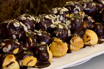 Profiteroles with chocolate cream and almond chips