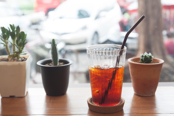 Iced americano on wooden table near the window, Lifestyle