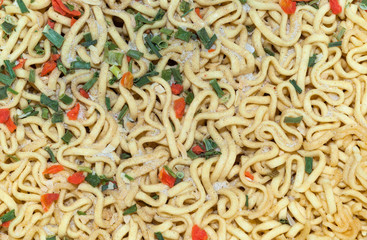 Texture of dry vermicelli noodles closeup sprinkled with spices