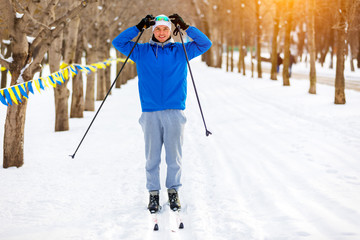 man rides cross-country skiing in winter Park