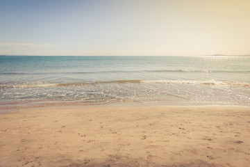 Fototapeta na wymiar Sandy beach with footprints in the sand. Toned.