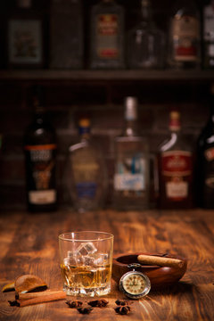 Glass of whiskey on rustic table.bar background