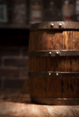 Naklejka na ściany i meble Barrel of whiskey on rustic table.blur bar background