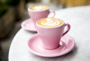Cup of hot latte coffee on marble table background for two loved people