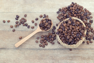 Top view of Coffee beans in weed basket with wooden spoon on table background. The selection of quality ingredients will help to get a good taste. Business and beverage concept.