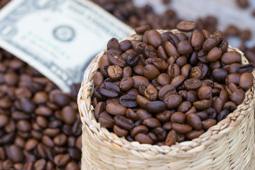 Coffee beans in weed basket with blur Dollar notes background. Doing business in this field. Quality raw materials must be selected. Investment concept.