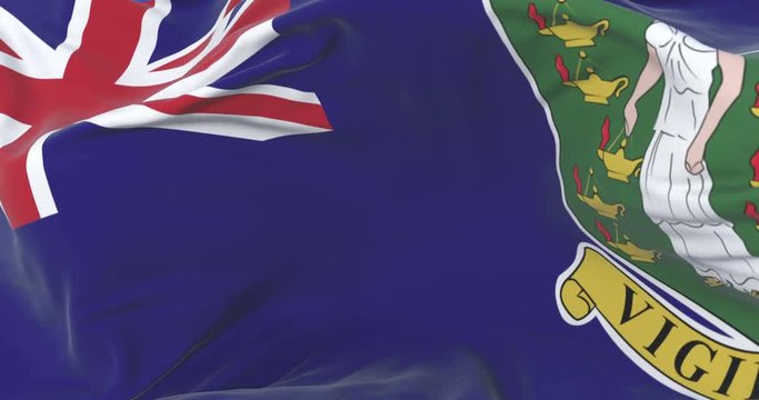 Flag of the British Virgin Islands waving at wind with blue sky, loop