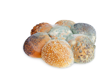 A photo of mold growing old bread with seeds isolated on white background. Food contamination, bad spoiled disgusting rotten wheat bread. Messthetics concept, food leftovers.