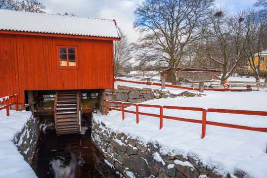 Winter scenery with river mill in Sweden