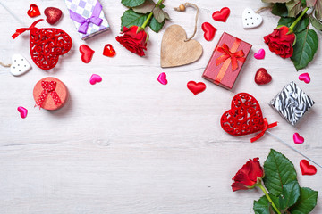 Wooden white background with red hearts, gifts and roses. The concept of Valentine Day