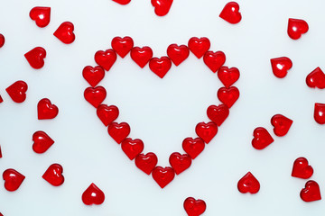 Background for St. Valentine's Day.
Decorative red hearts on a white background