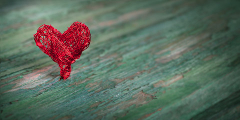 Red heart on shabby wood