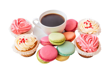 Coffee cup with macaroons and cupcakes isolated on white background. Selective focus