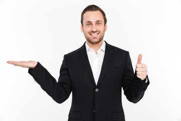 Smiling young businessman holding copyspace in hand