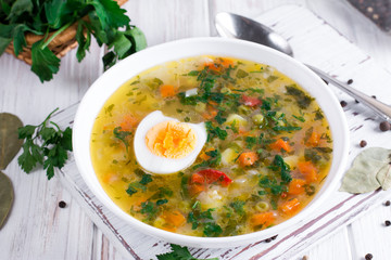 Summer vegetable soup with beans, peas, corn, carrots, chicken, egg, tasty healthy dish for the diet