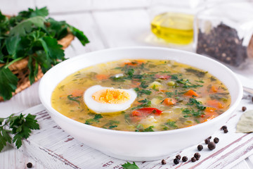 Summer vegetable soup with beans, peas, corn, carrots, chicken, egg, tasty healthy dish for the diet