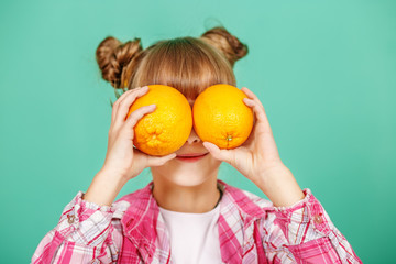 The child with oranges. The concept of healthy eating and vegetarianism.