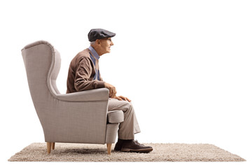 Mature man sitting in an armchair