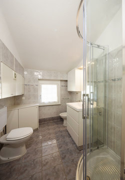 Bathroom with tiles and a large shower.