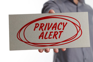 The concept of business, technology, the Internet and the network. Young businessman showing inscription: Privacy alert