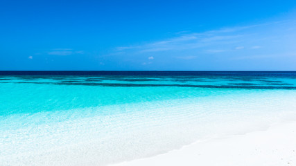 Fototapeta na wymiar Turquoise lagoon of a tropical island. Turquoise lagoon of a tropical island in the ocean. White sand on the beach. Summer paradise for relaxation.