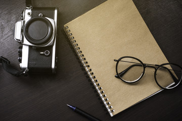 Glass on the book on the work desk.