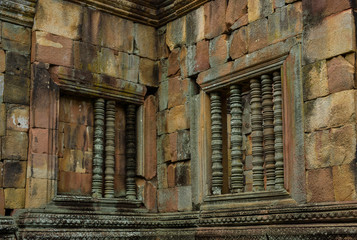 Fototapeta na wymiar The ancient carved stone bar window of Prasat Muang Tam an ancient Khmer-style temple complex built in Buriram Province, Thailand, which is built in the 10th -11th century.