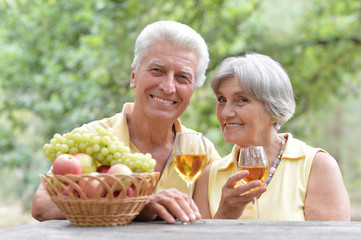 elderly couple drinking wine