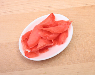 plate with Japanese pickled ginge on wood background.