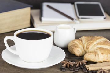 Black coffee white cup with croissant bread retro style.