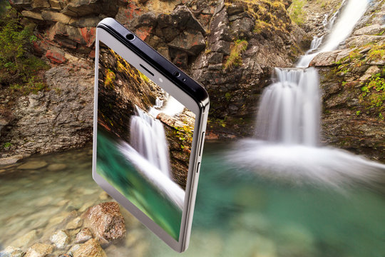 Landscape with a beautiful waterfall and a smartphone with a photo of this waterfall on a mountain river, a collage