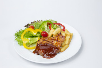 Pork shoulder Steak with fresh salad and french fried and BBQ sauce on white background