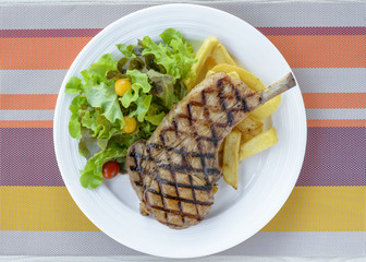 Pork Chop Steak served with fresh salad and french fried