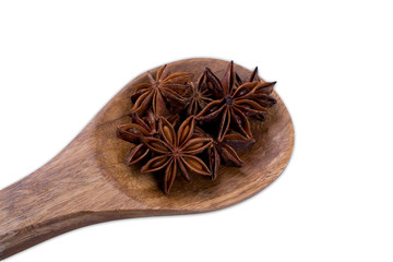 Anise star on wooden spoon isolated on white background