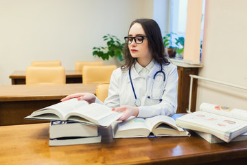 a medical student for textbooks. The study of surgery by a beautiful girl in the library
