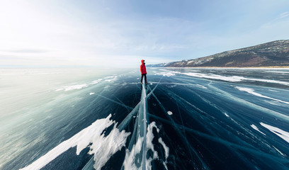 Panorama man stand on cracks on blue ice of Lake Baikal from Olkhon © Baikal360