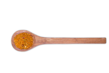 A pile of a yellow spice mix for chicken  on wooden spoon isolated on white background. Spices consist paprika onion garlic mustard coriander thyme celery turmeric fennel black pepper