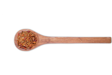 A pile of a yellow spice mix for on wooden spoon isolated on white background. Spices consist...