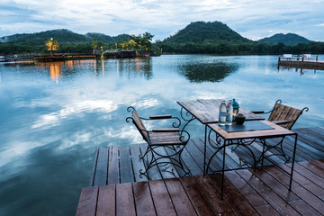 Outdoor restaurant with beautiful mountain view on the lake in the evening