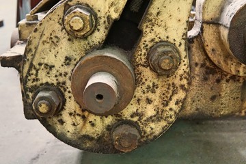 Grain Image: Close up of old machine factory made of steel and used in the past. Broken and rustic machine left over in abandon factory. Image of aged equipment with rust and gear part.