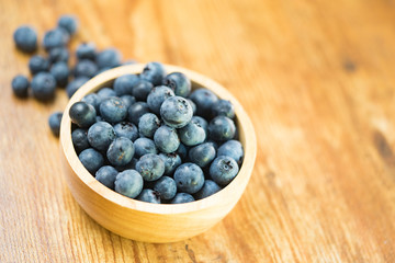 Freshly picked blueberries in wooden bowl.Bilberry on wooden Background. Blueberry antioxidant.Concept for healthy eating and nutrition.
