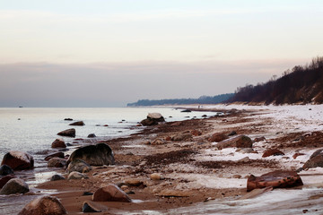 The evening sun glinting off the rocky seashore