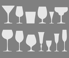 Vector set of white wineglass and glass icons placed on gray background
