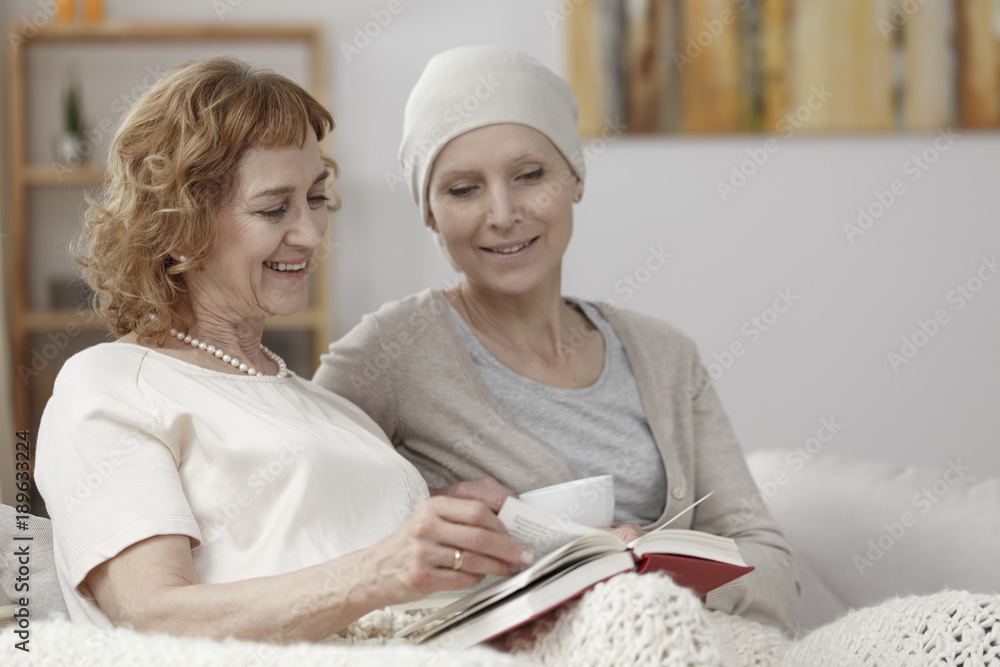 Sticker mother reading book to daughter