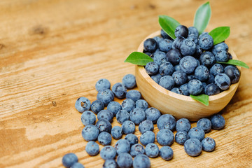 Freshly picked blueberries in wooden bowl.Bilberry on wooden Background. Blueberry antioxidant.Concept for healthy eating and nutrition.