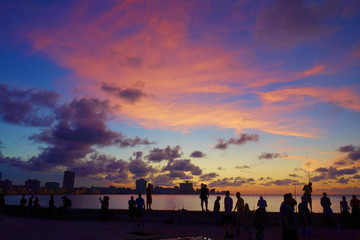 Sunset at Malecon, the famous Havana promenades where Habaneros, lovers and most of all individual...